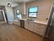 Kitchen with a stainless steel dishwasher, a gold faucet, white cabinets, and a marble bench under the window at 808 25Th W Ave, Palmetto, FL 34221