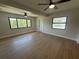 Spacious living room with two ceiling fans, tile floors, and impact windows offering plenty of natural light at 808 25Th W Ave, Palmetto, FL 34221
