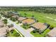 Stunning aerial view of the home, showcasing the tile roof, proximity to the golf course, and surrounding community at 8206 Heritage Grand Pl, Bradenton, FL 34212