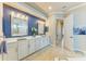 Bright bathroom features double vanity, wall mirror, and tile flooring at 8206 Heritage Grand Pl, Bradenton, FL 34212