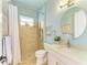 Bright bathroom features tiled walk-in shower, vanity, and round mirror at 8206 Heritage Grand Pl, Bradenton, FL 34212