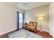 Serene bedroom features neutral carpet, reading chair, and natural light at 8206 Heritage Grand Pl, Bradenton, FL 34212