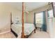 Bedroom features four-poster bed, ceiling fan, and natural light at 8206 Heritage Grand Pl, Bradenton, FL 34212