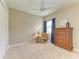 Cozy bedroom with neutral carpet, chest of drawers, and ceiling fan at 8206 Heritage Grand Pl, Bradenton, FL 34212