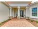 Elegant front entrance with stone accents, a brick walkway, and a decorative glass front door at 8206 Heritage Grand Pl, Bradenton, FL 34212