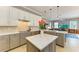 Spacious kitchen with white cabinets, stainless steel appliances and kitchen island at 8206 Heritage Grand Pl, Bradenton, FL 34212