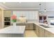 Well-equipped kitchen with a center island, stainless steel appliances, and a stylish tile backsplash at 8206 Heritage Grand Pl, Bradenton, FL 34212