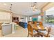Open-concept living area with a stylish dining table and chairs overlooking the backyard pool at 8206 Heritage Grand Pl, Bradenton, FL 34212