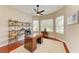 Inviting home office with hardwood floors, built-in shelving, and natural light at 8206 Heritage Grand Pl, Bradenton, FL 34212