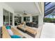 Covered patio featuring tile flooring, comfortable seating, and outdoor dining area at 8206 Heritage Grand Pl, Bradenton, FL 34212