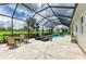 Enclosed pool area with golf course views, a spa, and outdoor seating at 8206 Heritage Grand Pl, Bradenton, FL 34212