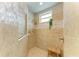 Modern shower with decorative tiles, a rainfall shower head, and a built-in bench at 8206 Heritage Grand Pl, Bradenton, FL 34212