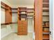 Well-organized walk-in closet with custom wood shelving and drawers at 8206 Heritage Grand Pl, Bradenton, FL 34212