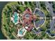 Stunning aerial view of community clubhouse featuring pools, parking, and meticulously maintained green spaces at 8312 Catamaran Cir, Lakewood Ranch, FL 34202