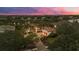 An aerial view of a luxury home at twilight with lush landscaping and a private driveway at 8312 Catamaran Cir, Lakewood Ranch, FL 34202