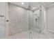 Modern bathroom with glass shower, marble tile, and updated fixtures at 8312 Catamaran Cir, Lakewood Ranch, FL 34202