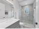 Bright bathroom features marble counter, gray vanity, and a frameless glass shower at 8312 Catamaran Cir, Lakewood Ranch, FL 34202