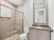 Bright bathroom with tiled shower, glass doors, and granite countertop at 8312 Catamaran Cir, Lakewood Ranch, FL 34202