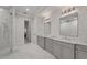 Elegant bathroom featuring double vanity, marble floors, and frameless glass shower at 8312 Catamaran Cir, Lakewood Ranch, FL 34202