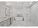 Luxurious bathroom with a soaking tub, marble countertops, and mosaic tile at 8312 Catamaran Cir, Lakewood Ranch, FL 34202