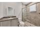 Bathroom with gray vanity, framed glass shower, and plantation shutters at 8312 Catamaran Cir, Lakewood Ranch, FL 34202