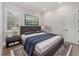 Bedroom with queen size bed, gray headboard, and matching gray nightstands at 8312 Catamaran Cir, Lakewood Ranch, FL 34202