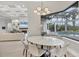 Dining area with views of the pool and living area with a fireplace at 8312 Catamaran Cir, Lakewood Ranch, FL 34202