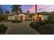 Elegant Mediterranean-style home featuring a circular driveway, lush landscaping, and a grand entrance at 8312 Catamaran Cir, Lakewood Ranch, FL 34202