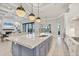 Kitchen island that opens to the living room and views of the pool and lanai at 8312 Catamaran Cir, Lakewood Ranch, FL 34202