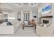 Bright living room with coffered ceiling, modern fireplace, and open floor plan to kitchen at 8312 Catamaran Cir, Lakewood Ranch, FL 34202