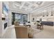 Spacious living room with a coffered ceiling, fireplace, and an open layout flowing into the dining and kitchen areas at 8312 Catamaran Cir, Lakewood Ranch, FL 34202