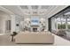 Inviting living room with coffered ceilings, fireplace, and sliding glass doors leading to the pool area at 8312 Catamaran Cir, Lakewood Ranch, FL 34202
