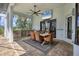 A covered patio with a stone outdoor kitchen and a dining table with seating at 8312 Catamaran Cir, Lakewood Ranch, FL 34202