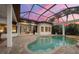 A screened-in pool and spa area with plenty of seating and views of the surrounding property at 8312 Catamaran Cir, Lakewood Ranch, FL 34202