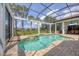 Beautiful screened in pool with spa, outdoor seating, and serene landscaping at 8312 Catamaran Cir, Lakewood Ranch, FL 34202