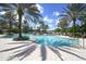 A luxurious swimming pool with palm trees, lounge chairs, and a relaxing atmosphere at 8312 Catamaran Cir, Lakewood Ranch, FL 34202