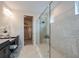 Bright bathroom with granite countertops, a glass-enclosed shower, and a view into the walk-in closet at 8583 Big Dipper Dr, Sarasota, FL 34241