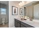 Spacious bathroom with a double vanity, decorative mirror, and elegant fixtures, creating a luxurious feel at 8583 Big Dipper Dr, Sarasota, FL 34241