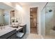 Well-lit bathroom featuring dual sinks, granite countertops, a vanity and glass enclosed shower at 8583 Big Dipper Dr, Sarasota, FL 34241