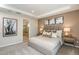 Nicely appointed bedroom featuring neutral tones, a tray ceiling, and a door to the ensuite bath at 8583 Big Dipper Dr, Sarasota, FL 34241
