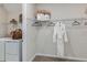 Walk-in closet area with wire shelving, clothing rods, and laundry area in the background at 8583 Big Dipper Dr, Sarasota, FL 34241