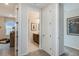 Hallway leading to a bathroom, showcasing the home's layout and design at 8583 Big Dipper Dr, Sarasota, FL 34241