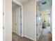 Hallway with doors leading to other rooms, showcasing the home's layout at 8583 Big Dipper Dr, Sarasota, FL 34241