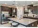Modern kitchen with stainless steel appliances, island and hanging pendant lights at 8583 Big Dipper Dr, Sarasota, FL 34241
