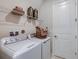 Convenient laundry room with modern appliances and shelving for storage solutions at 8583 Big Dipper Dr, Sarasota, FL 34241