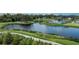 Scenic walking path by a pond surrounded by lush landscaping and nearby neighborhood amenities at 8583 Big Dipper Dr, Sarasota, FL 34241