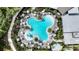 Aerial view of a clover-shaped resort-style pool surrounded by palm trees and lounge chairs at 8583 Big Dipper Dr, Sarasota, FL 34241
