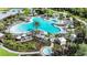 Aerial view of the resort pool area with lush landscaping, lounge chairs, umbrellas, and cabanas at 8583 Big Dipper Dr, Sarasota, FL 34241
