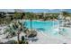 Gorgeous resort-style pool featuring a slide, beach entry, lounge chairs, and tropical landscaping at 8583 Big Dipper Dr, Sarasota, FL 34241