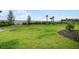 Expansive backyard with lush green grass and privacy landscaping creates a serene outdoor space at 8632 Snowfall St, Sarasota, FL 34241